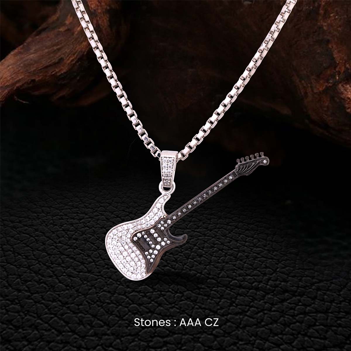 Two Tone Sterling Silver guitar pendant necklace with Chain on a dark textured background