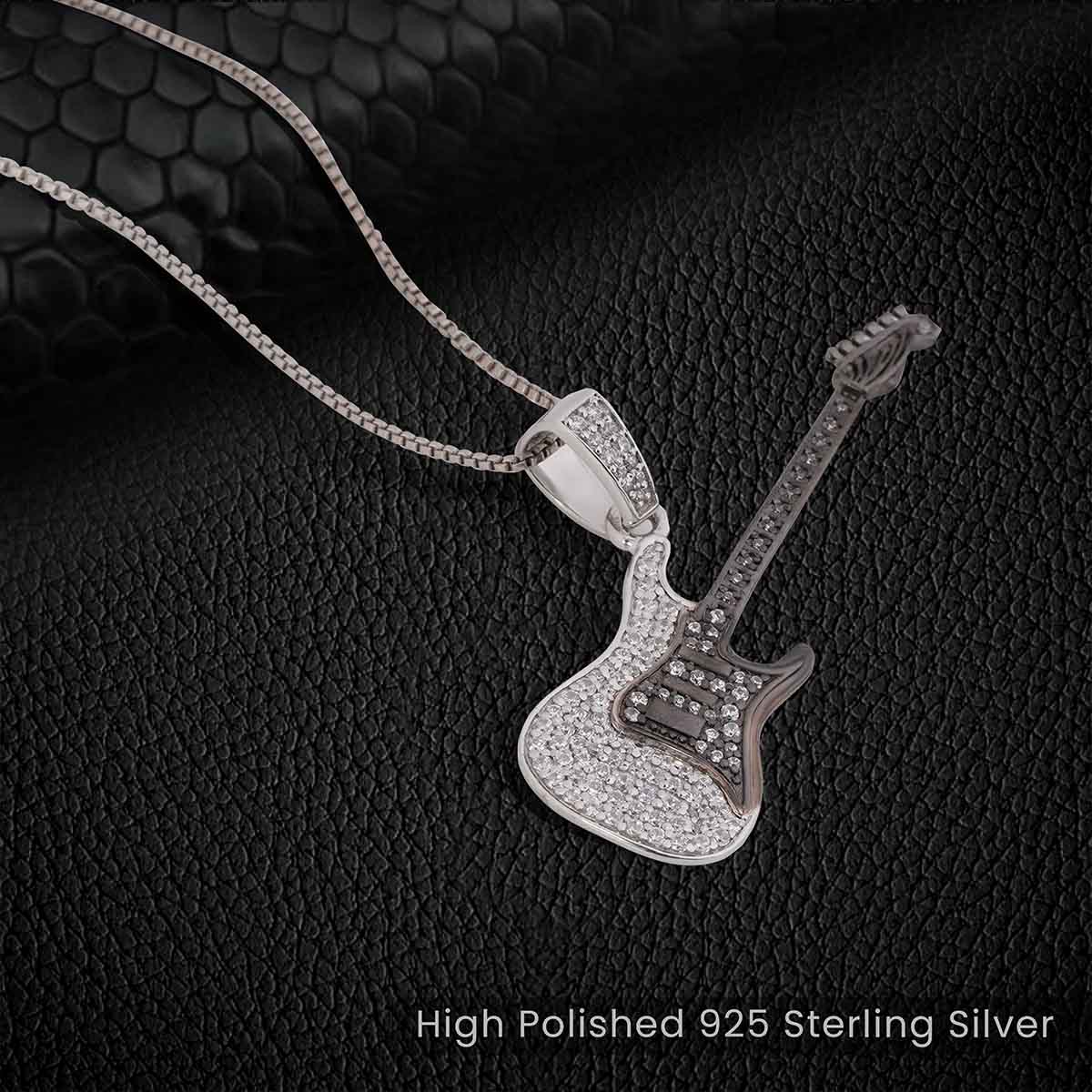 Two Tone Sterling Silver Diamond Studded Iced Out Guitar pendant Necklace with chain on a dark textured background