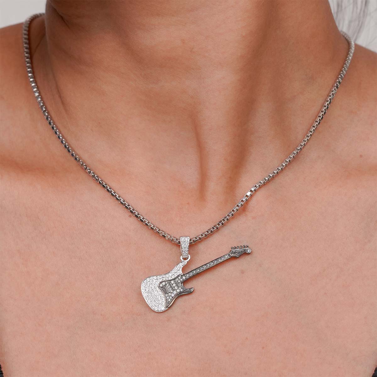 Two Tone Sterling Silver Diamond Studded Iced Out Guitar pendant necklace on a person's neck ( Model View)