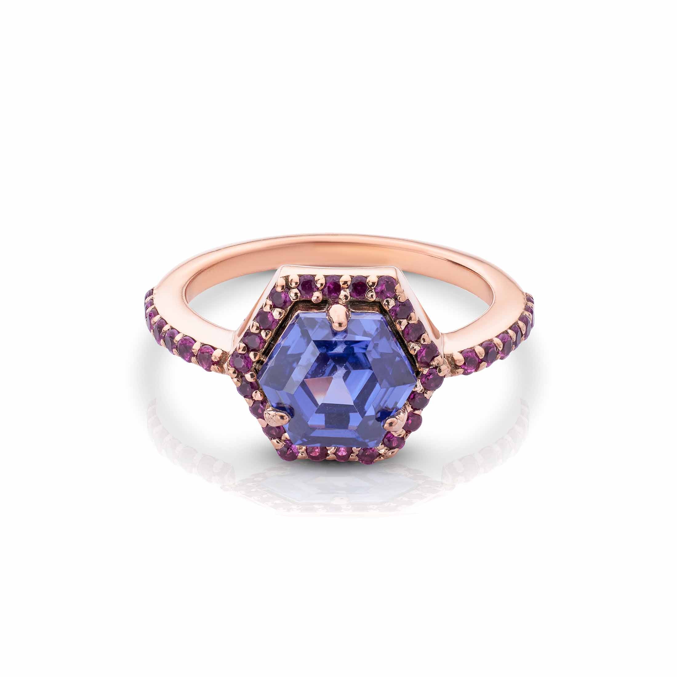 Rose gold hexagon ring with a violet center stone and purple gemstone halo on a pave-set band.