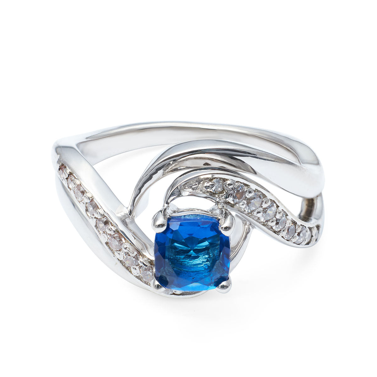 Elegant silver ring featuring a vibrant square blue stone and a curved, diamond-like pavé band.