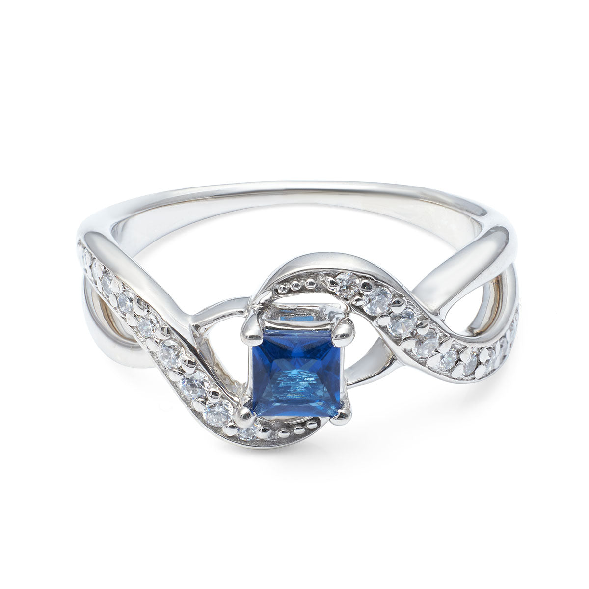Modern bypass-style ring with a square blue gemstone and a shimmering curved diamond-like halo.