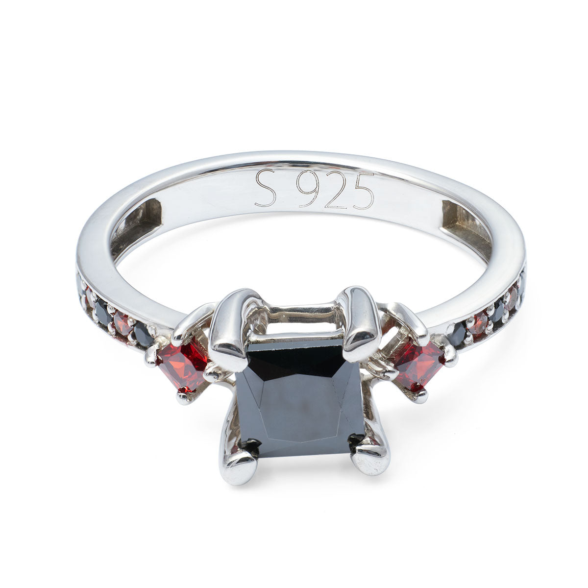 Silver ring with a central black stone and smaller red and clear stones on a white background