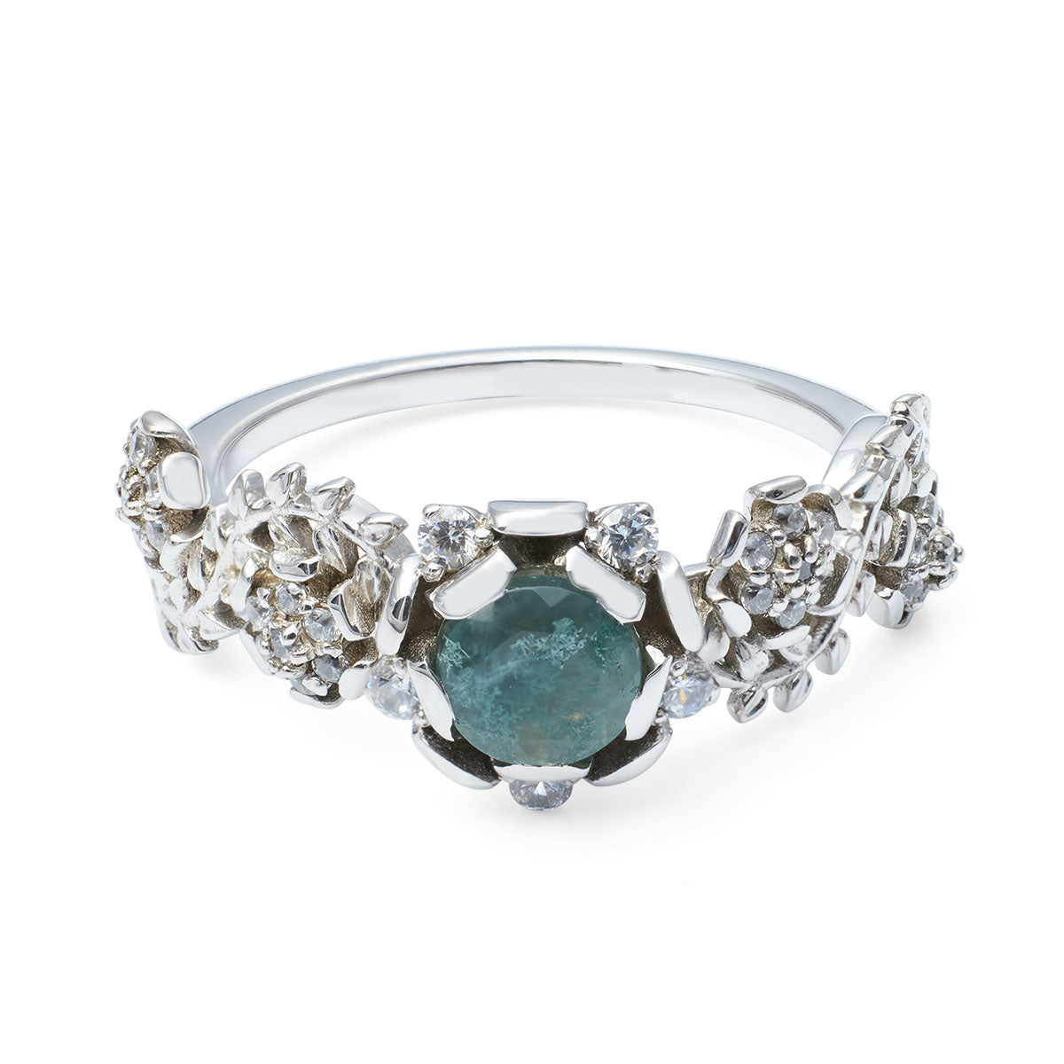 Nature-inspired silver ring with a teal gemstone and intricate flower-shaped side details.