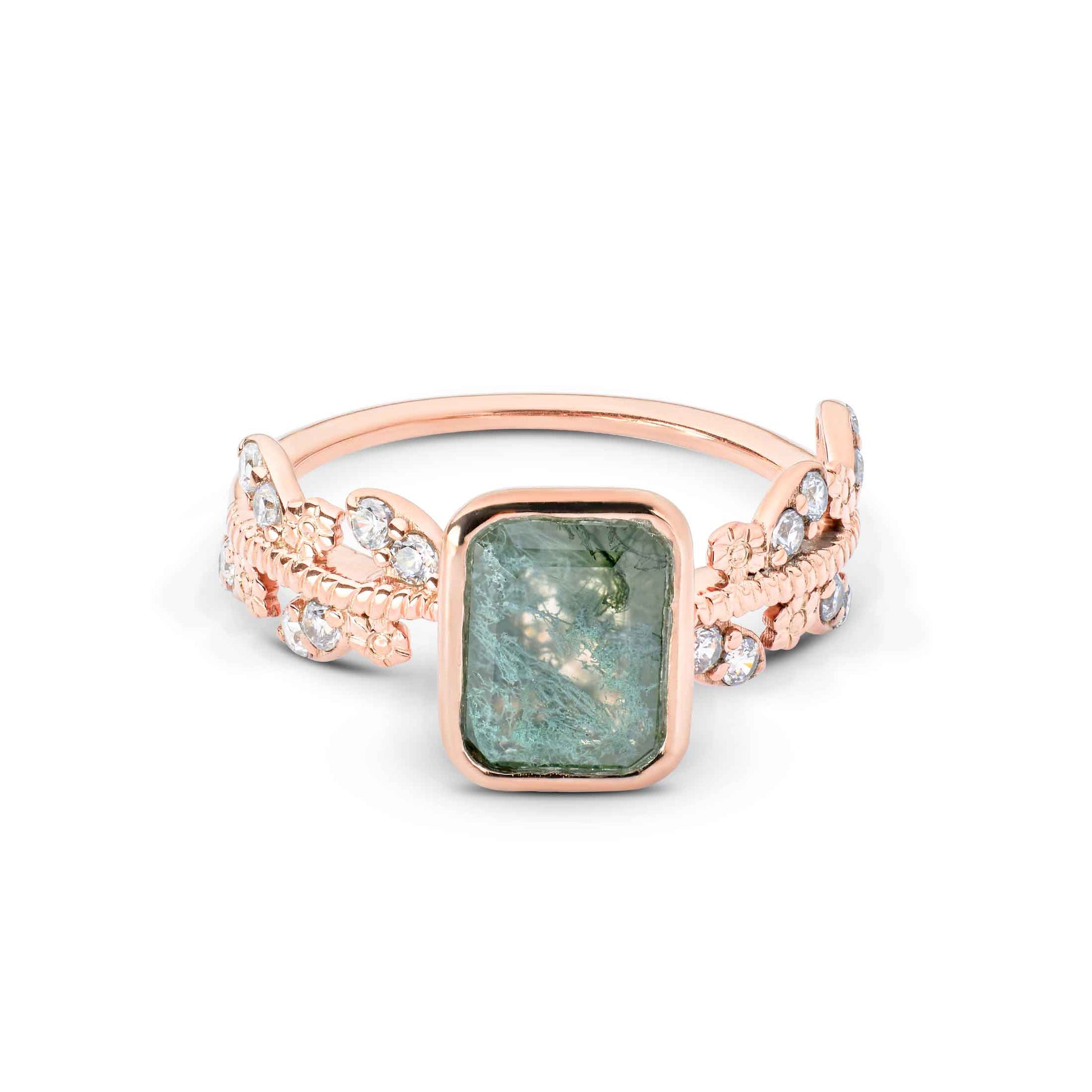 Rectangular green gemstone ring set in rose gold with intricate, shimmering leaf-style shoulders.