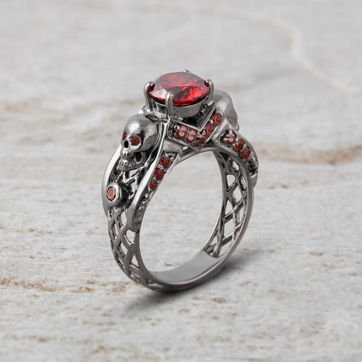 red garnet skull engagement ring with criss cross mesh design in sterling silver gun metal finish