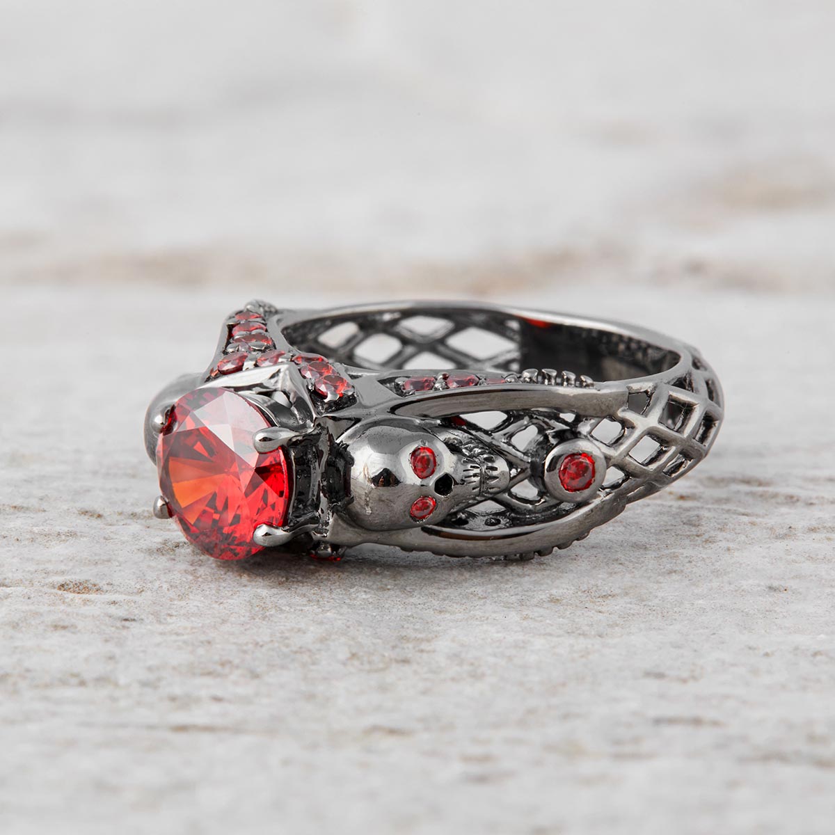red garnet skull engagement ring with criss cross mesh design in sterling silver gun metal finish