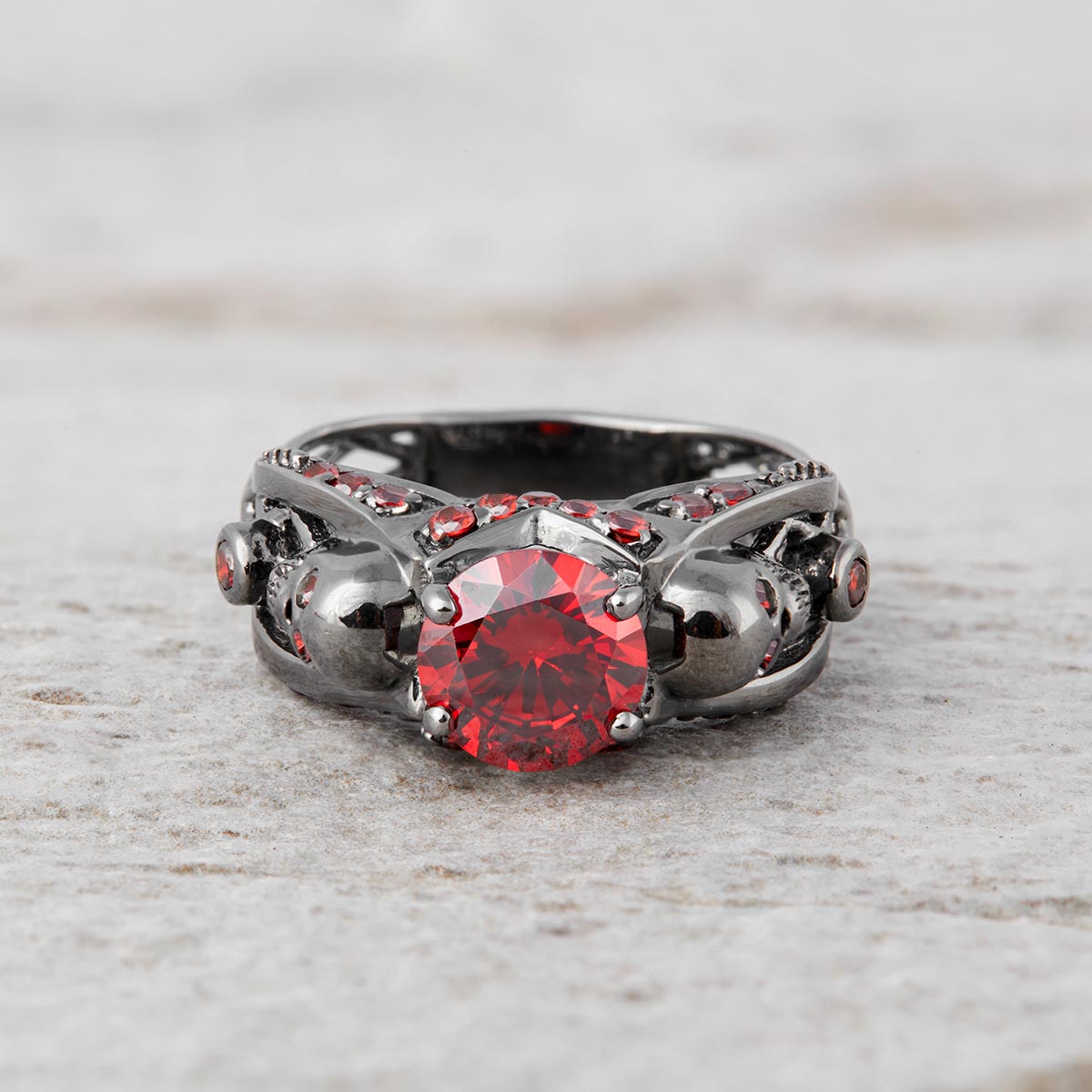 red garnet skull engagement ring with criss cross mesh design in sterling silver gun metal finish