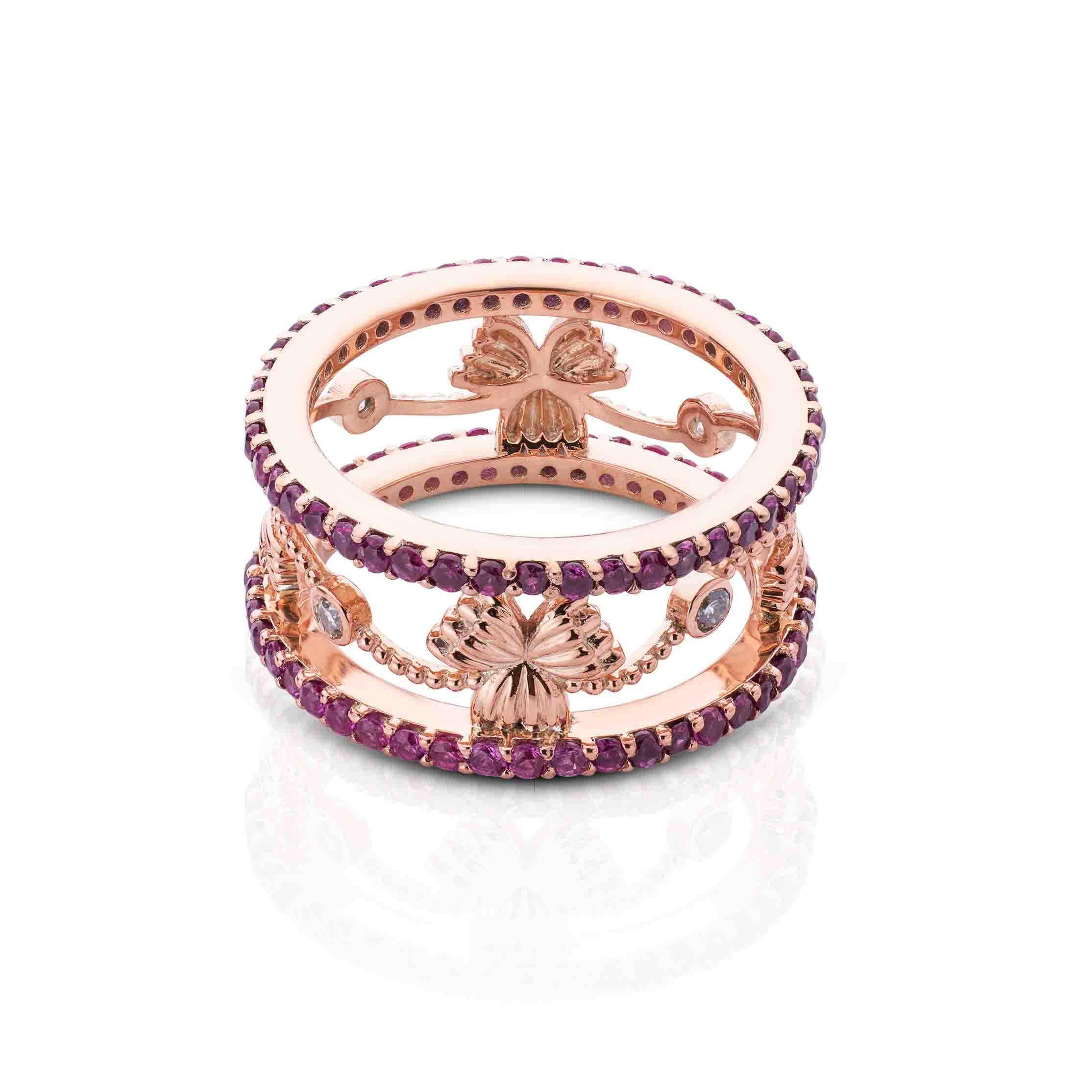 Wide rose gold band with parallel purple stone tracks connected by floral motifs and clear accents.