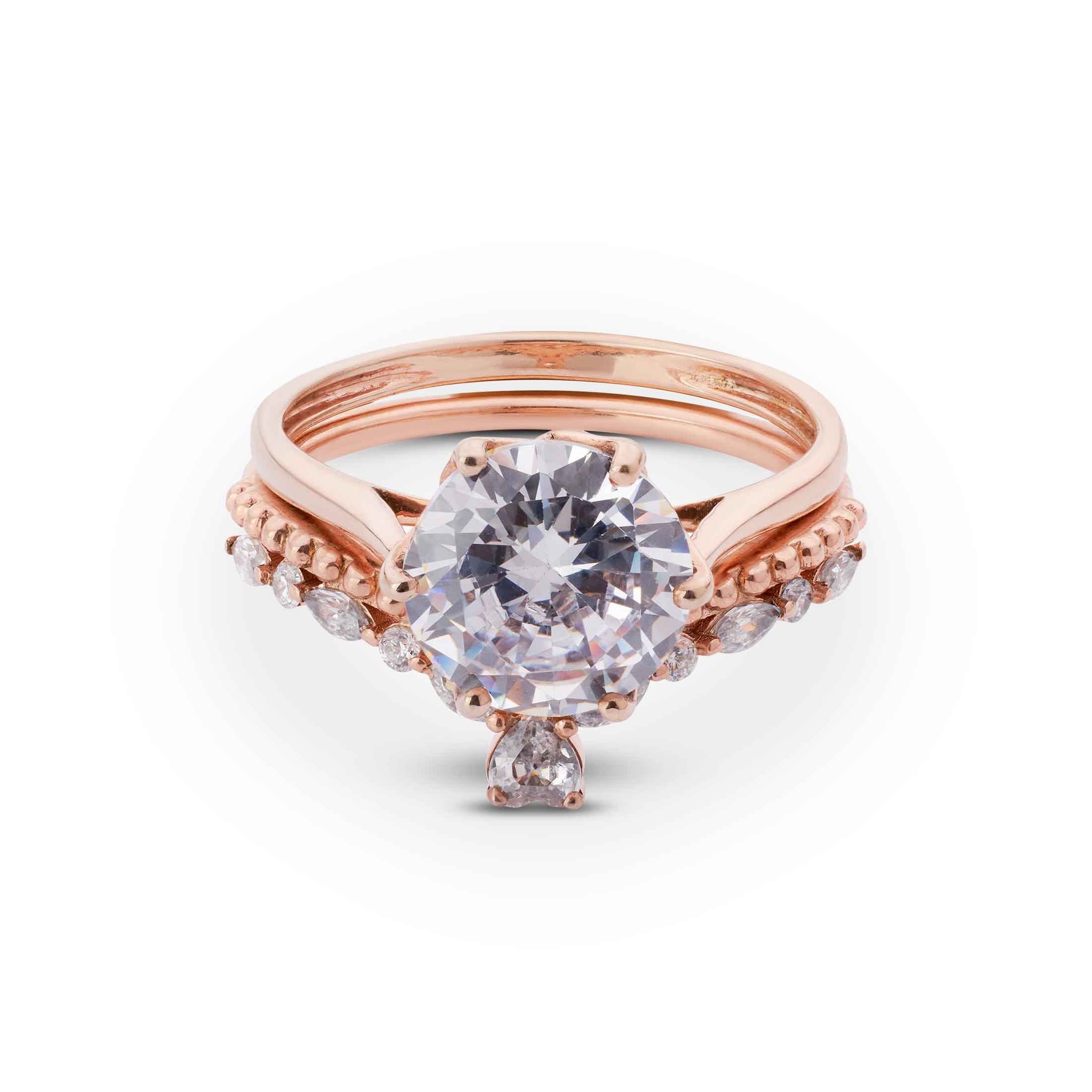 solitaire ring set in a polished rose gold six-prong mounting with diamond band.