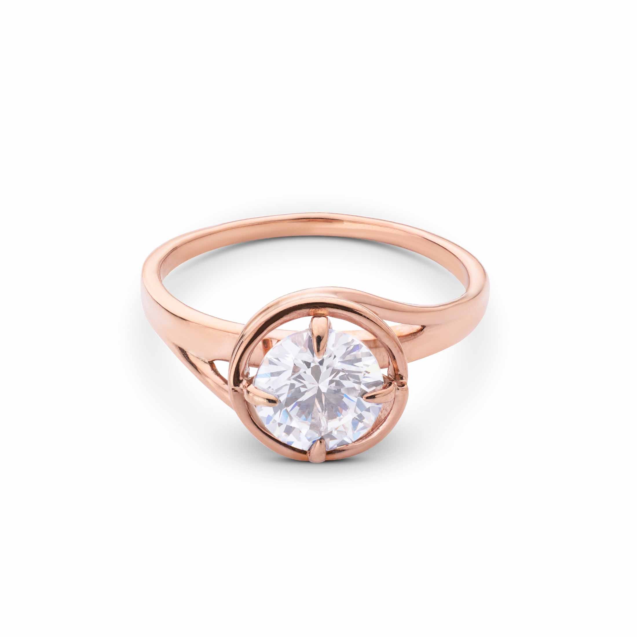 Elegant rose gold engagement ring with a round center stone and a modern, split bypass shank.