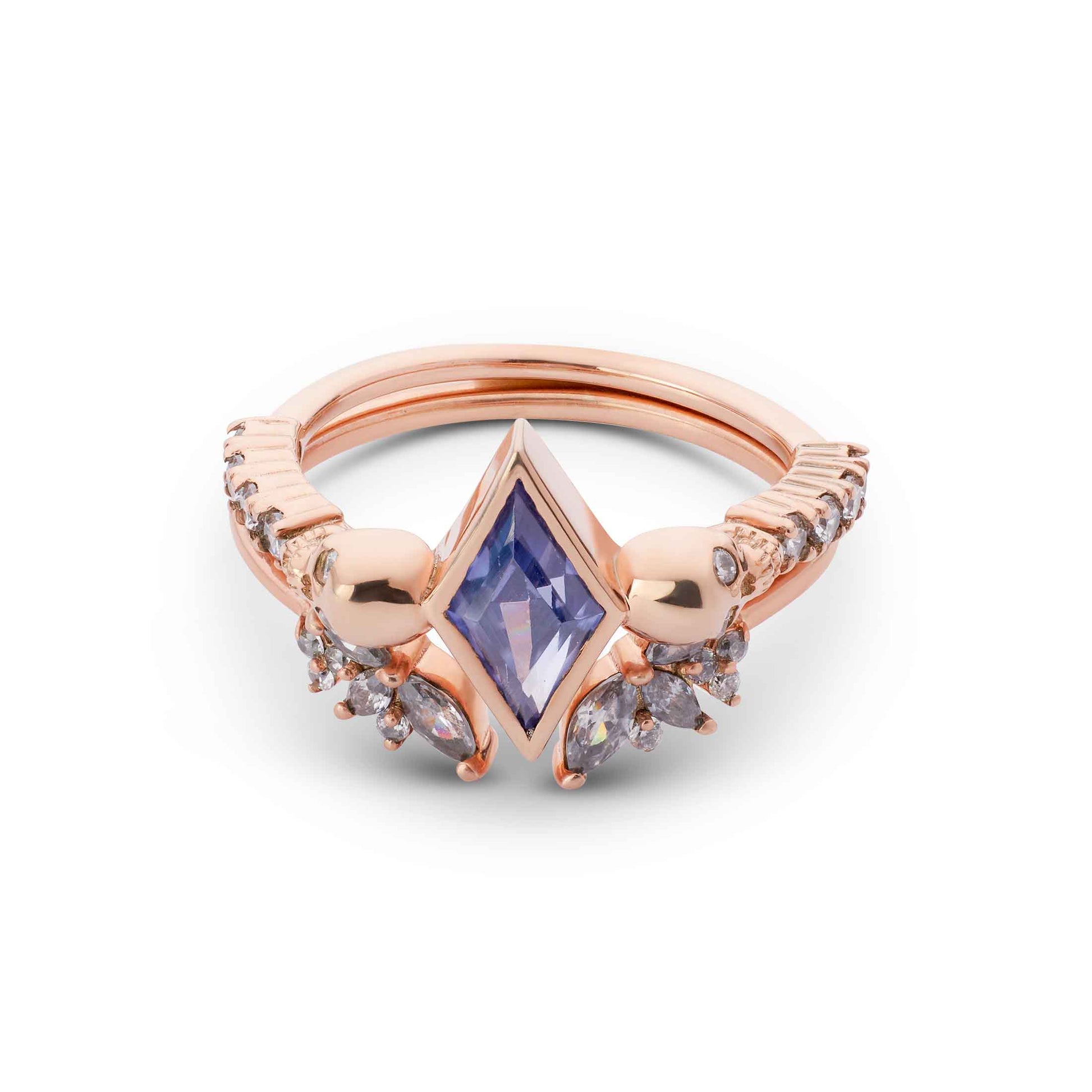 Kite-cut purple stone ring in rose gold with macabre skull details and pavé accents and leaf band