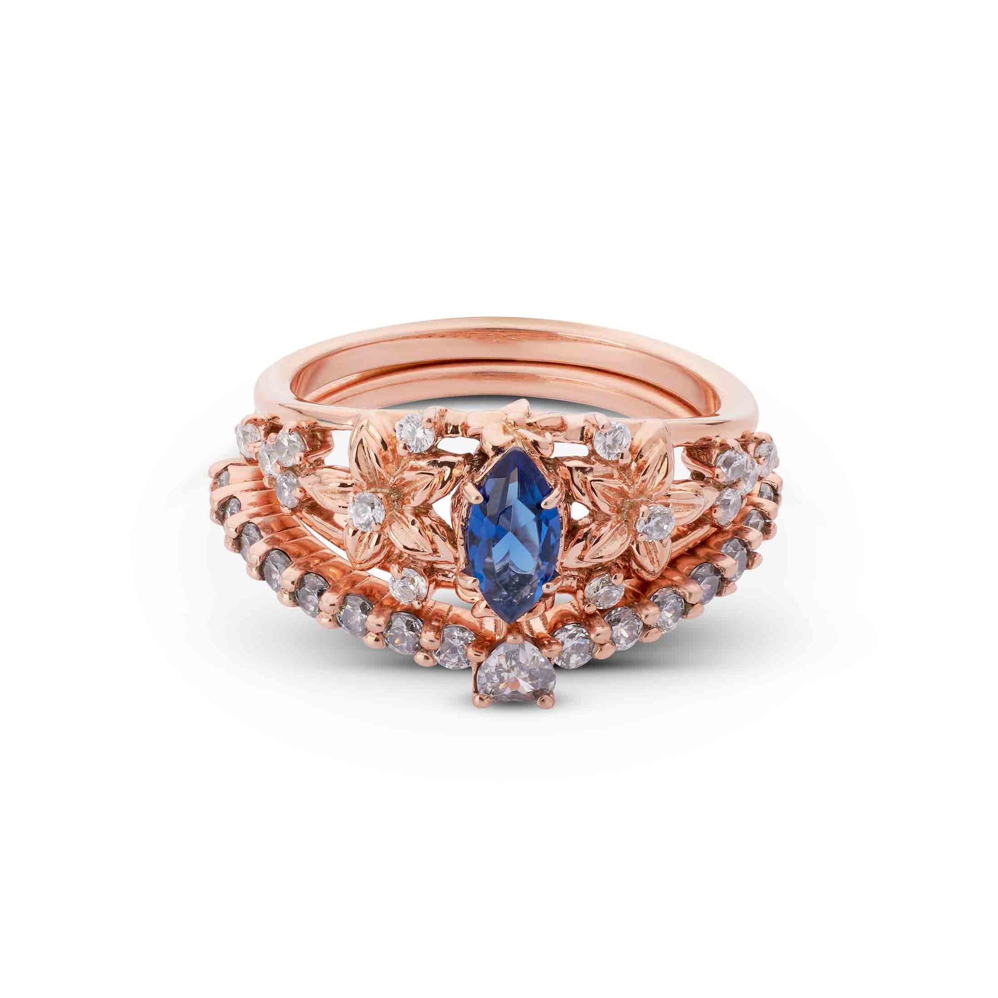 Nature-inspired rose gold ring with a blue marquise gem, petal details, and pavé wedding band.