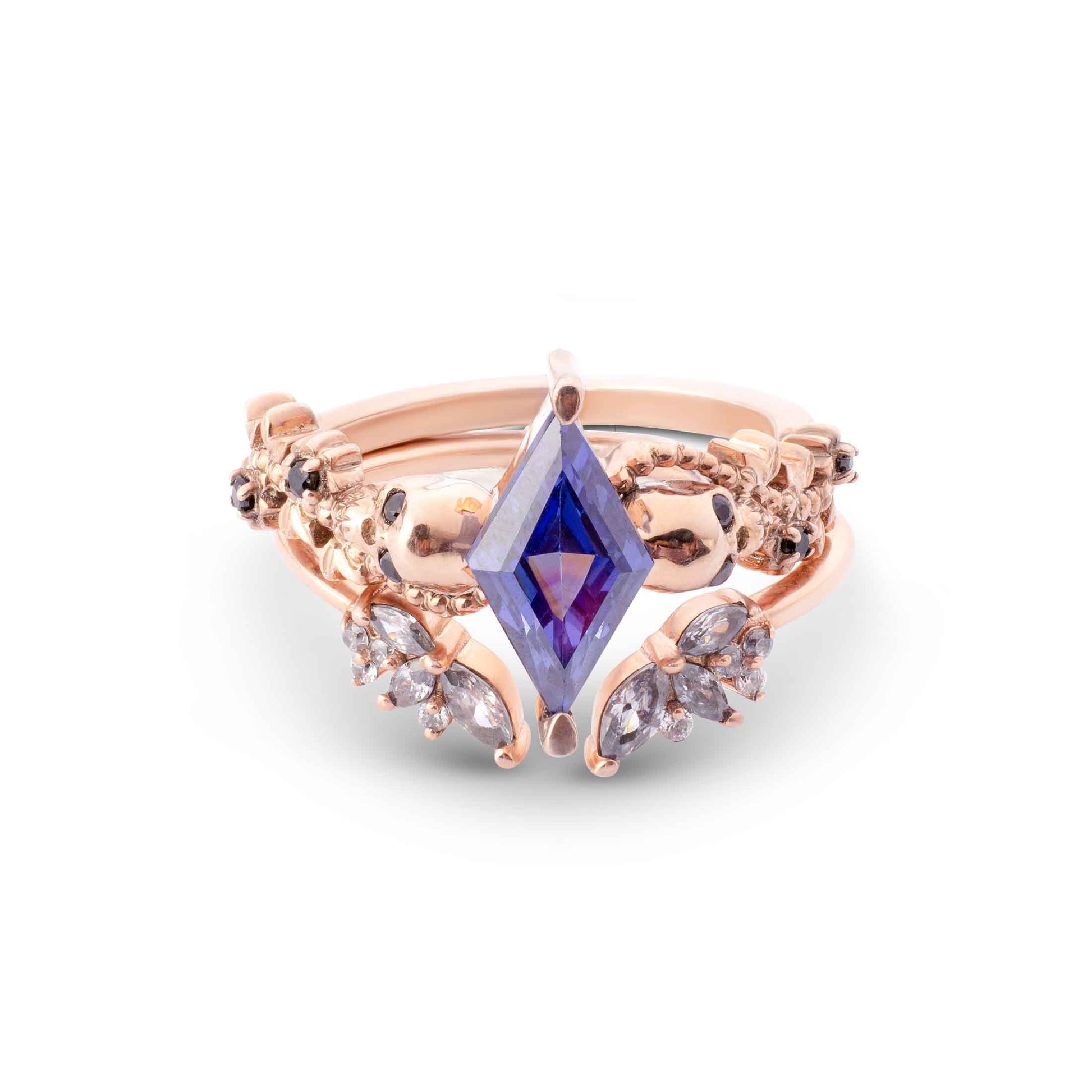 Nature-inspired rose gold ring jacket set with a blue marquise center and a V-shaped pavé band.