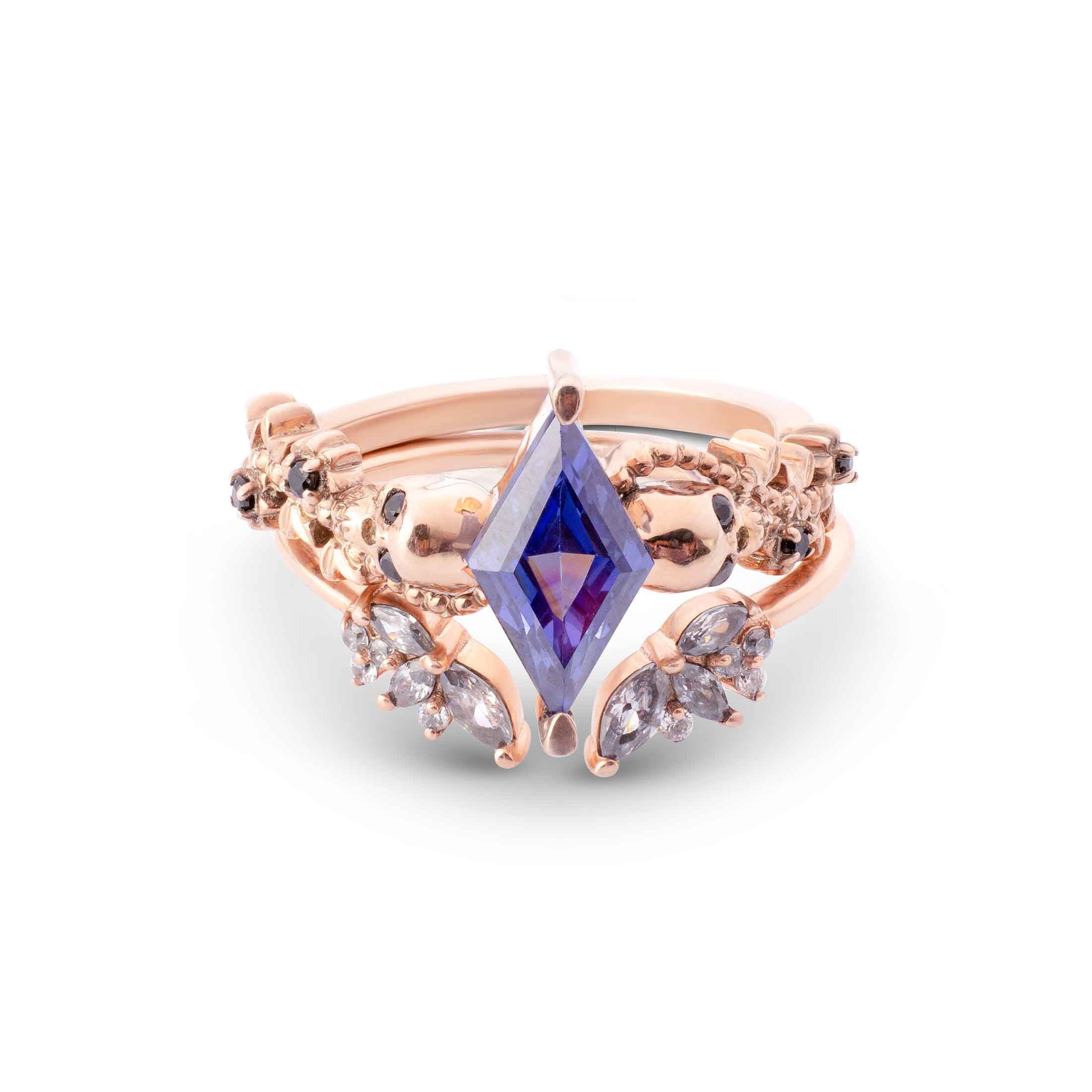 Nature-inspired rose gold ring jacket set with a blue marquise center and a V-shaped pavé band.
