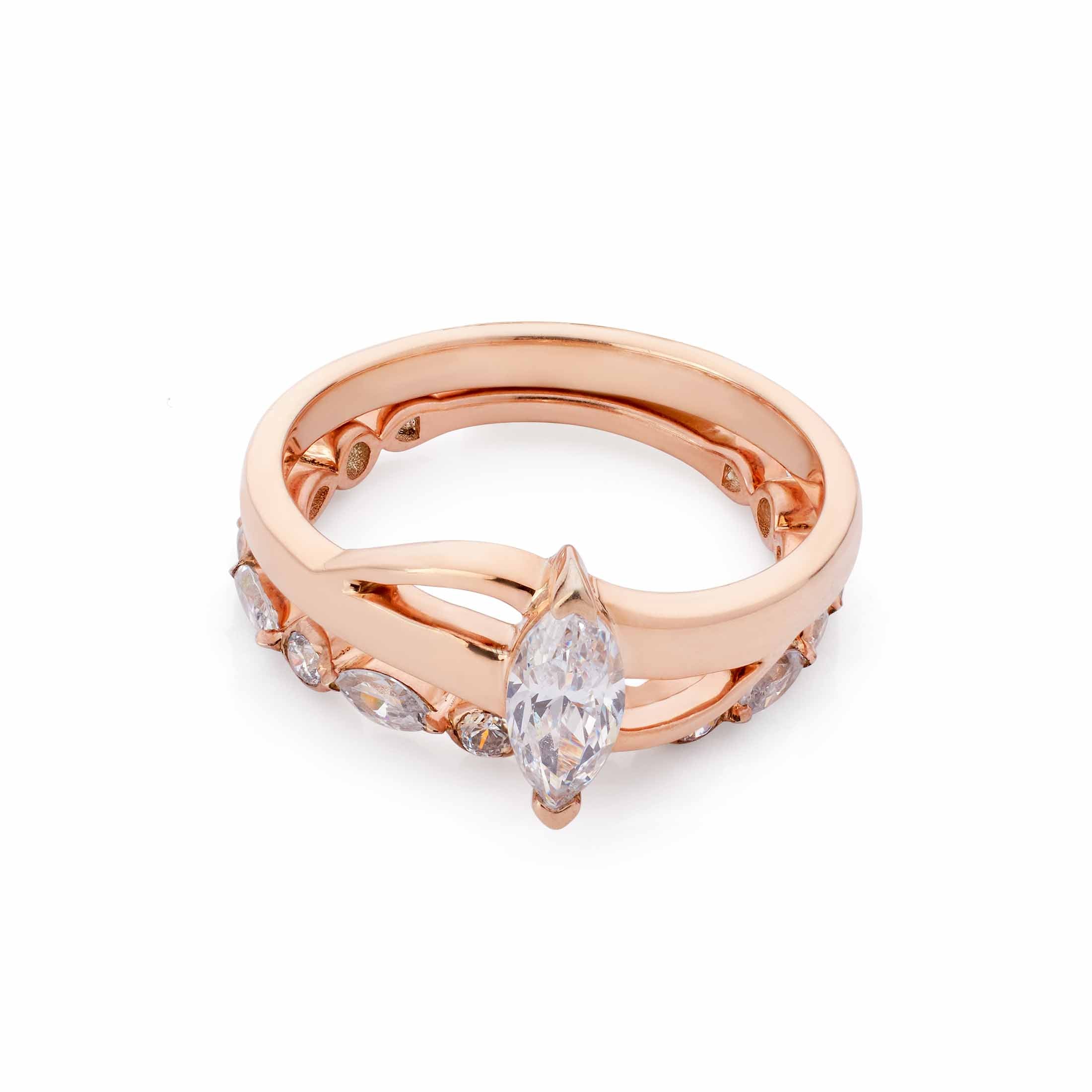  Stacked rose gold jewelry featuring a vertical marquise solitaire and a secondary diamond-set band.