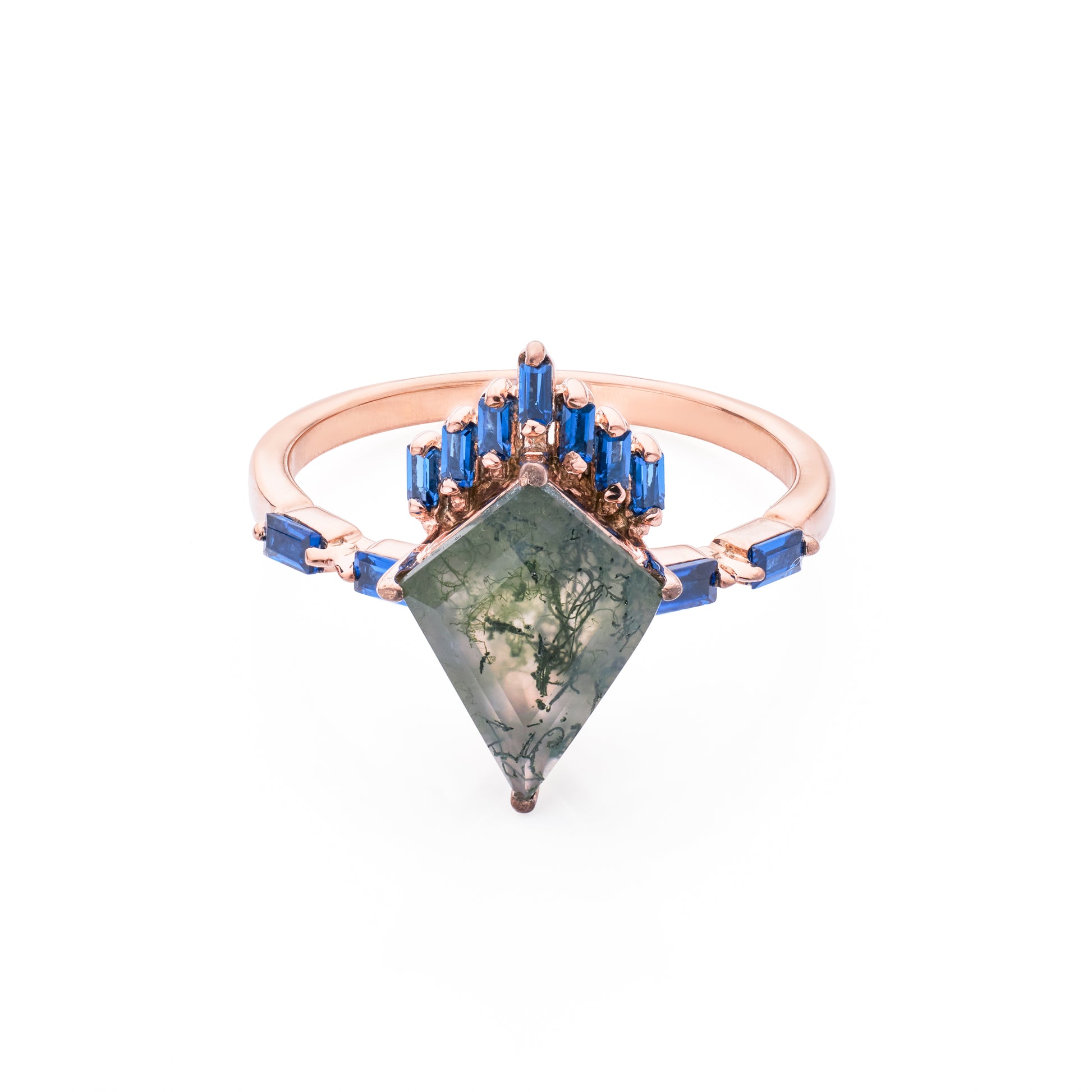 Jewelry ring with green gemstone and blue accents on a white background