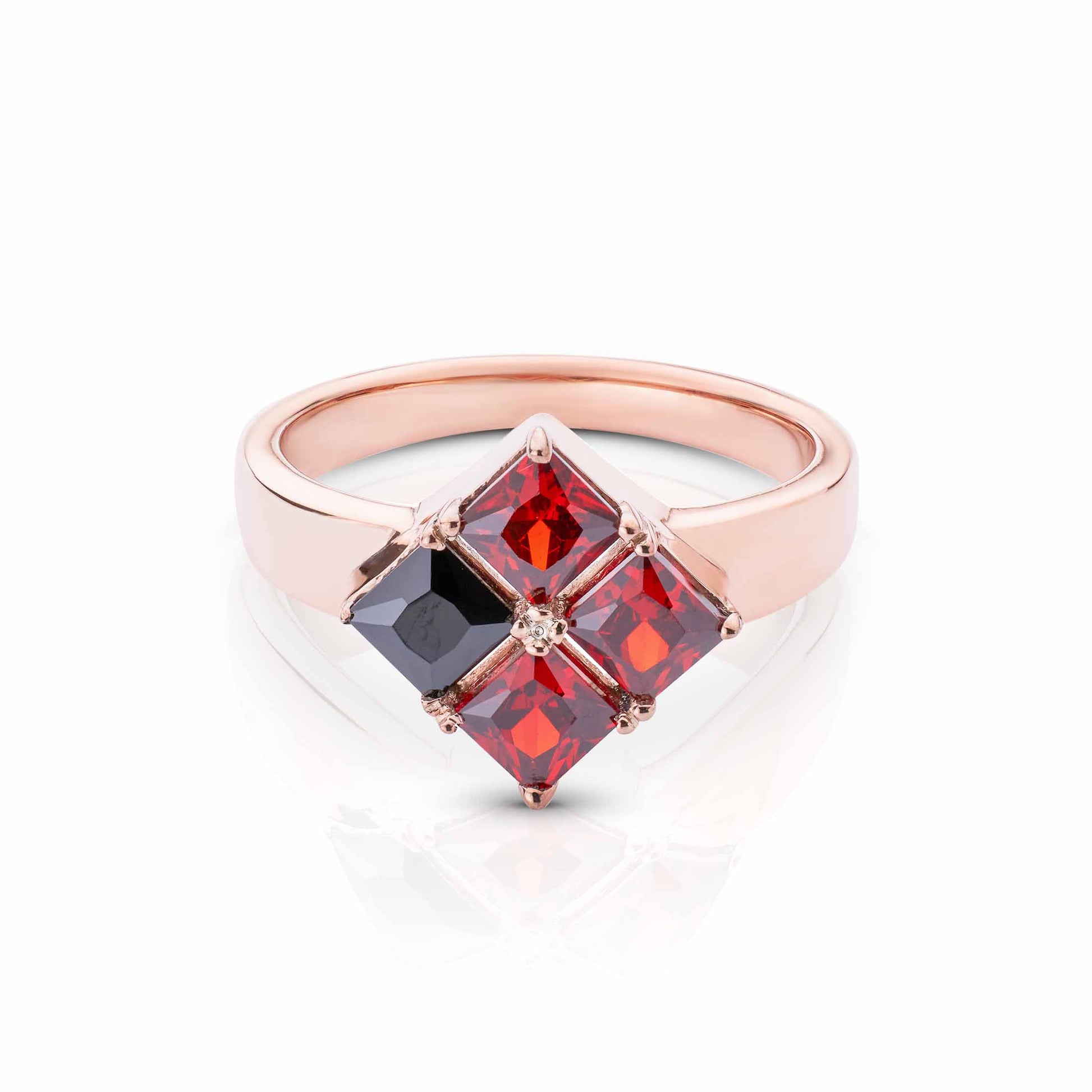 Modern rose gold jewelry with a diamond-shaped arrangement of vibrant red and deep black gems.