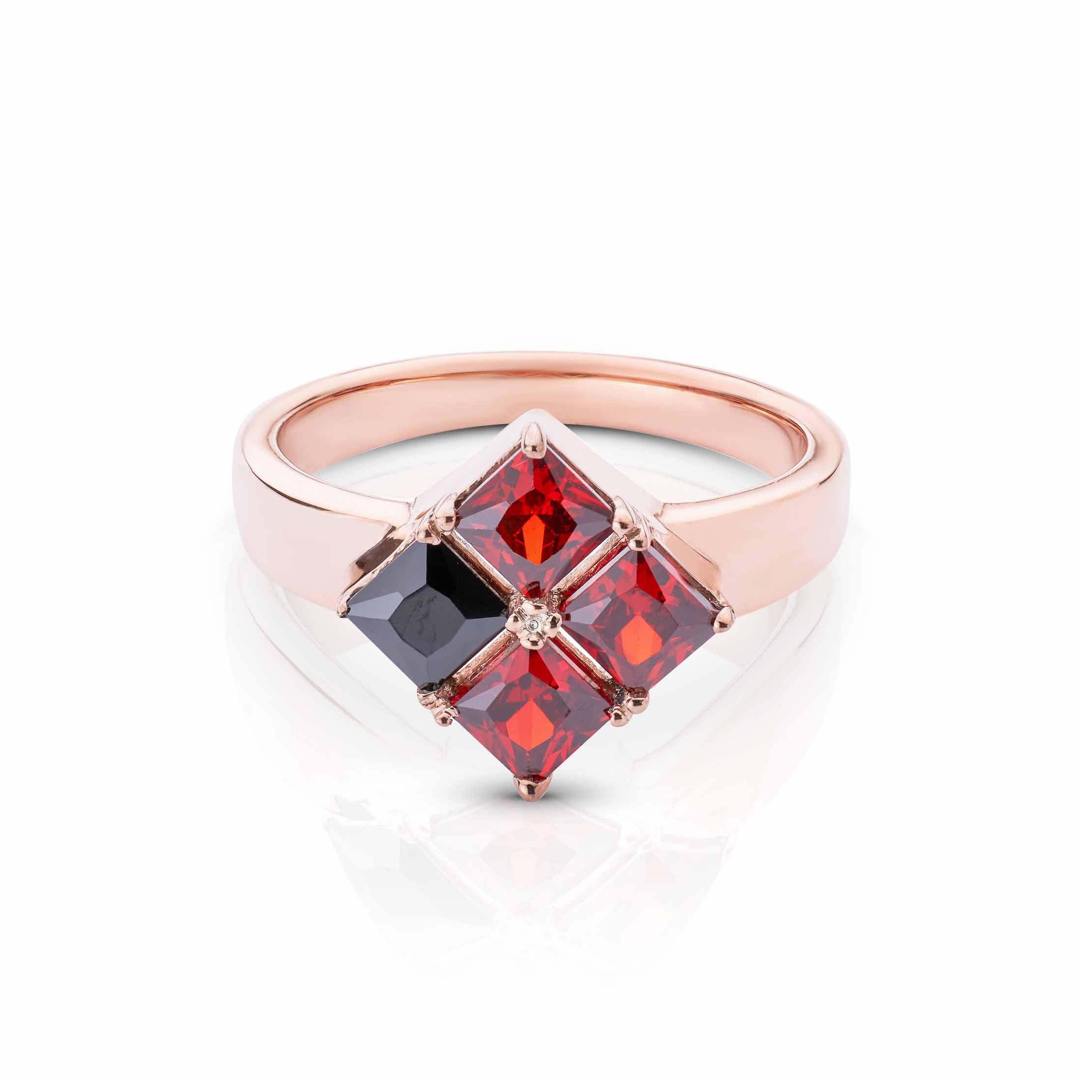 Modern rose gold jewelry with a diamond-shaped arrangement of vibrant red and deep black gems.