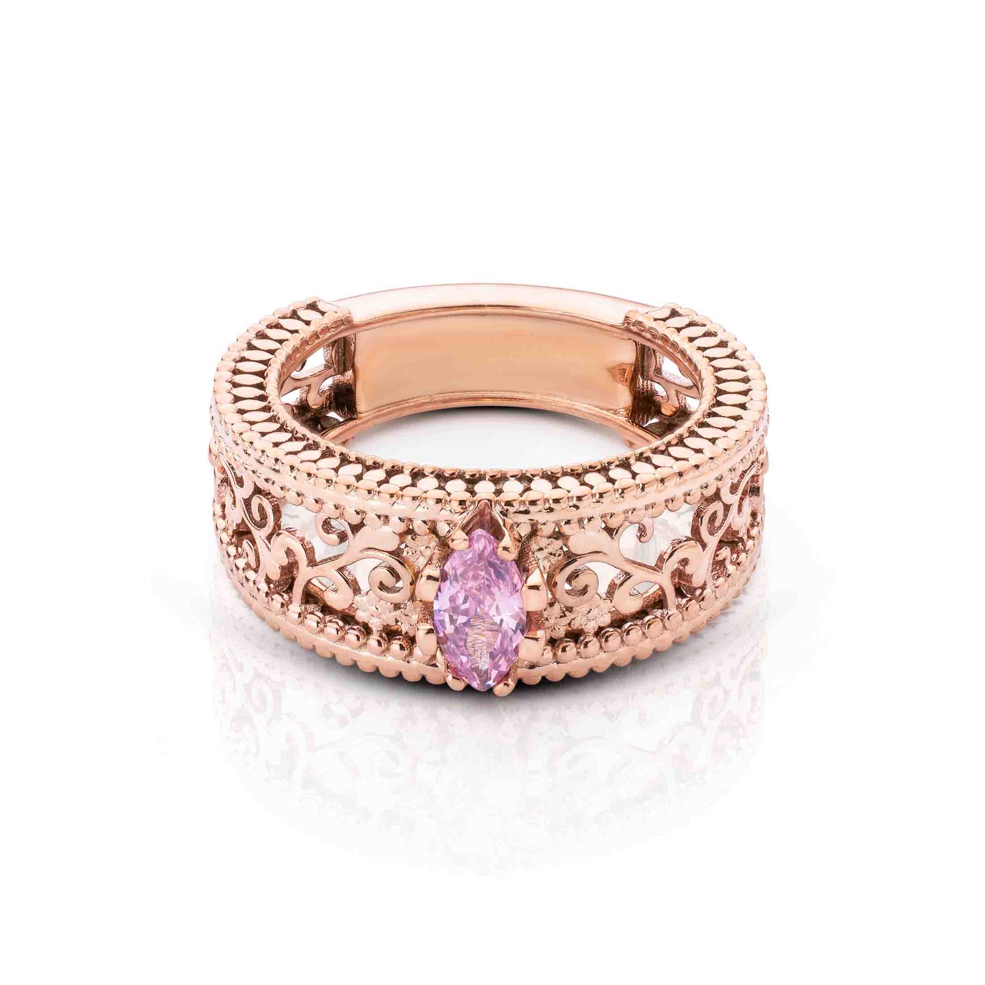 Wide filigree rose gold band showcasing a delicate pink marquise gemstone in a bezel setting.