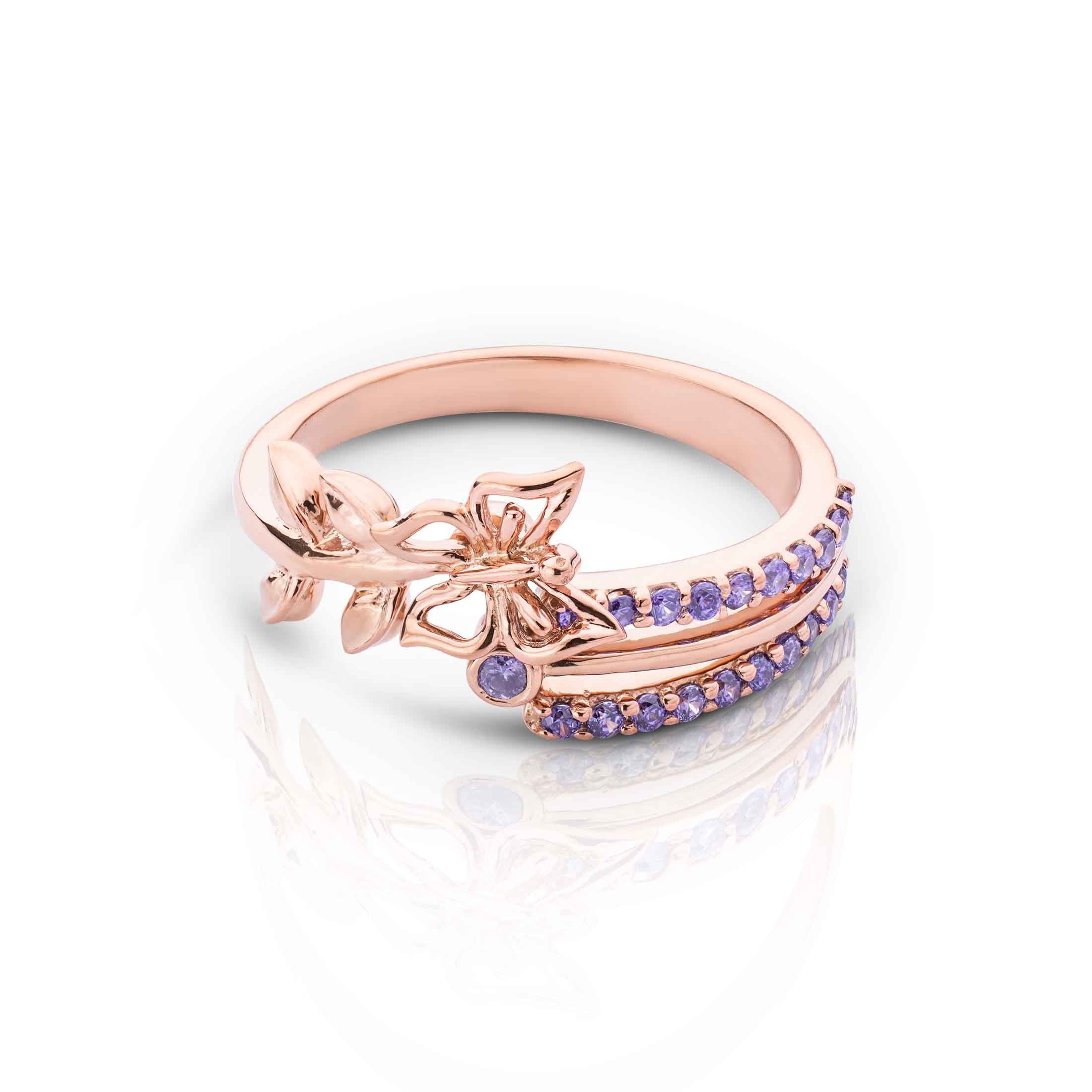Nature-inspired rose gold ring with a central butterfly, leafy accents, and two rows of purple gems.