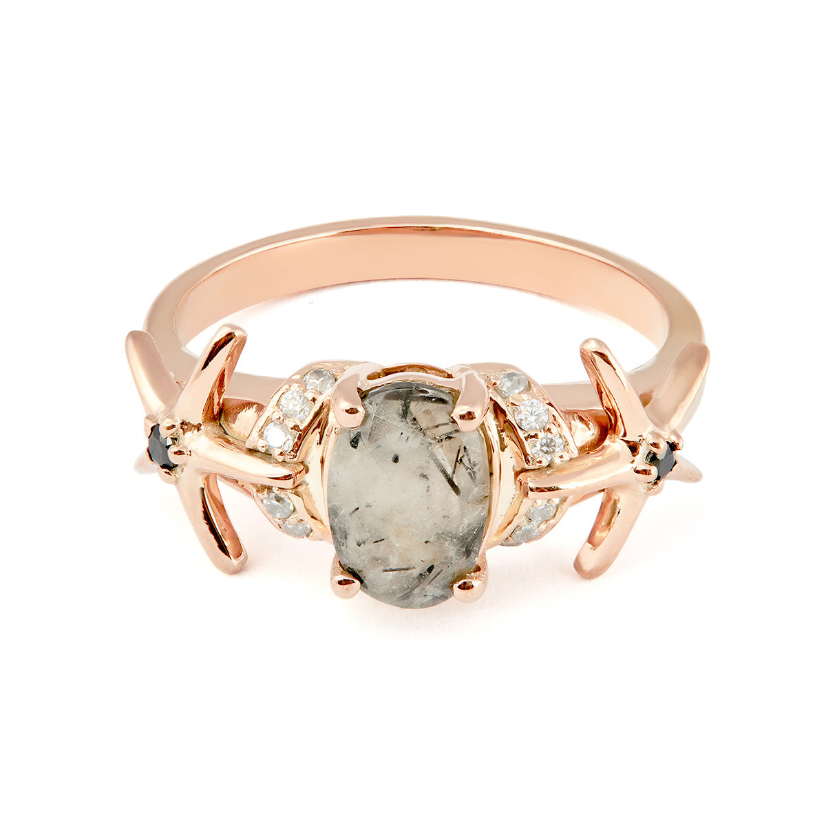 Ornate rose gold band holding an oval salt-and-pepper gemstone with star and diamond side detailing.