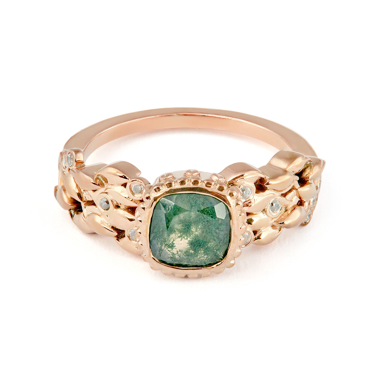 Cushion-cut moss agate ring in rose gold with an intricate textured leaf and diamond band.