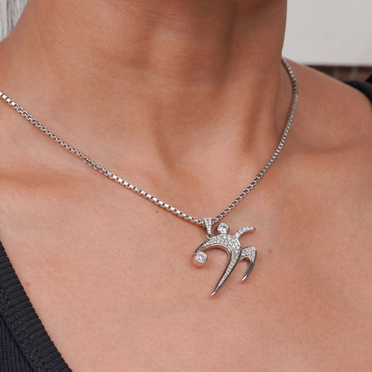 Sterling Silver Track and Field Shot Put Pendant Necklace on a person's neck