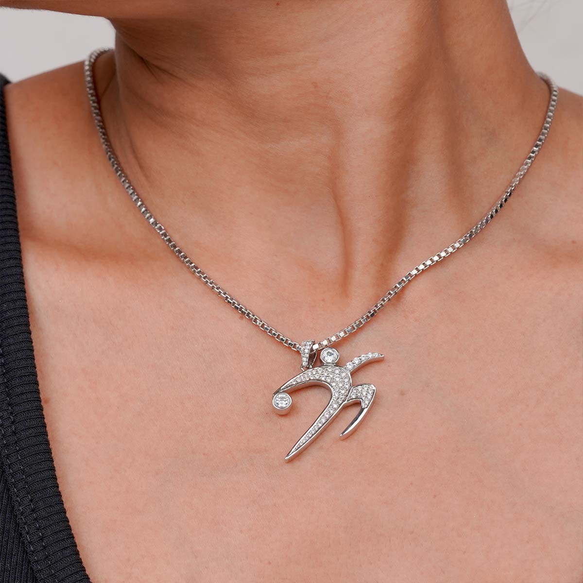 Sterling Silver Track and Field Shot Put Pendant Necklace on a person's neck