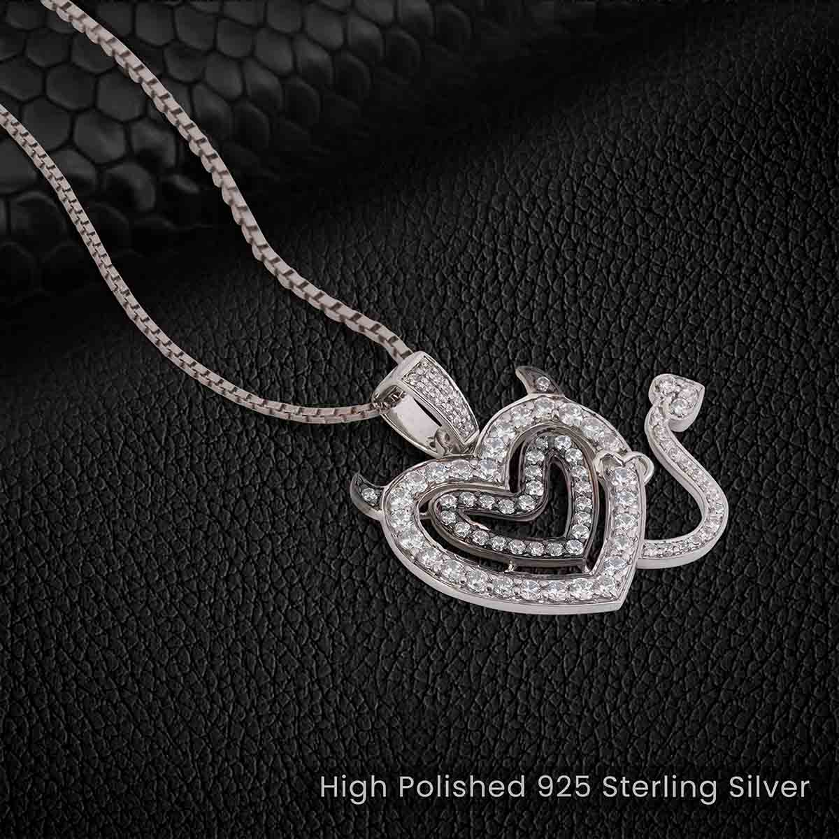 Silver necklace with a heart-shaped pendant on a black textured background