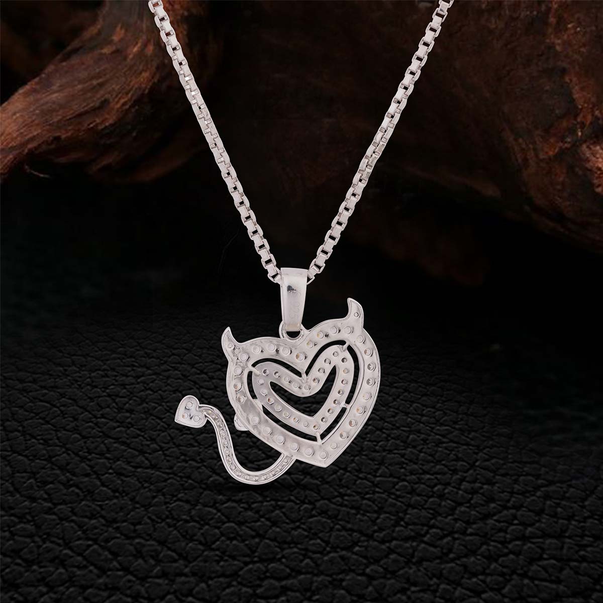 Backside of Sterling Silver Heart necklace on a dark textured background