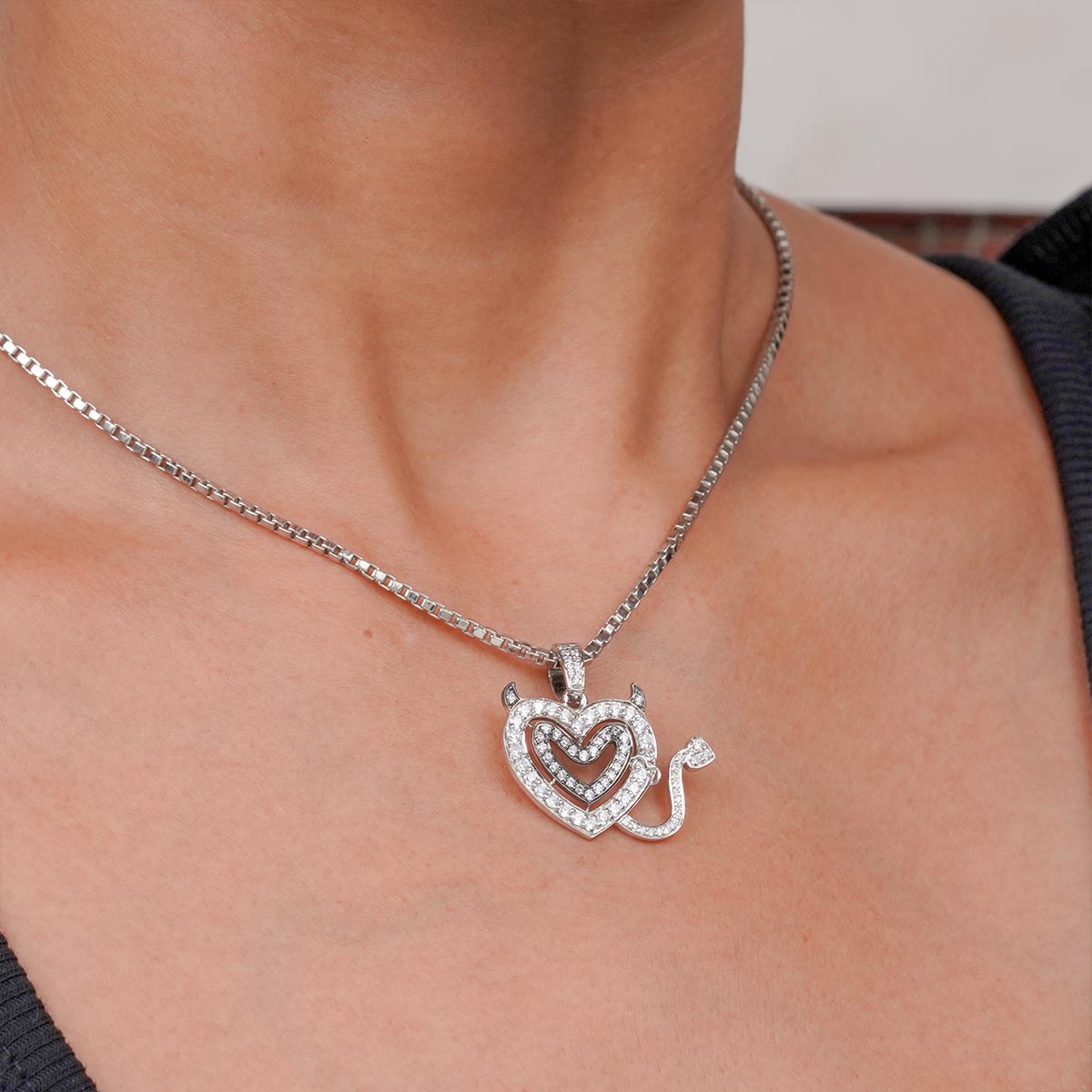 Two Tone Sterling Silver necklace with a heart-shaped pendant on a person's neck