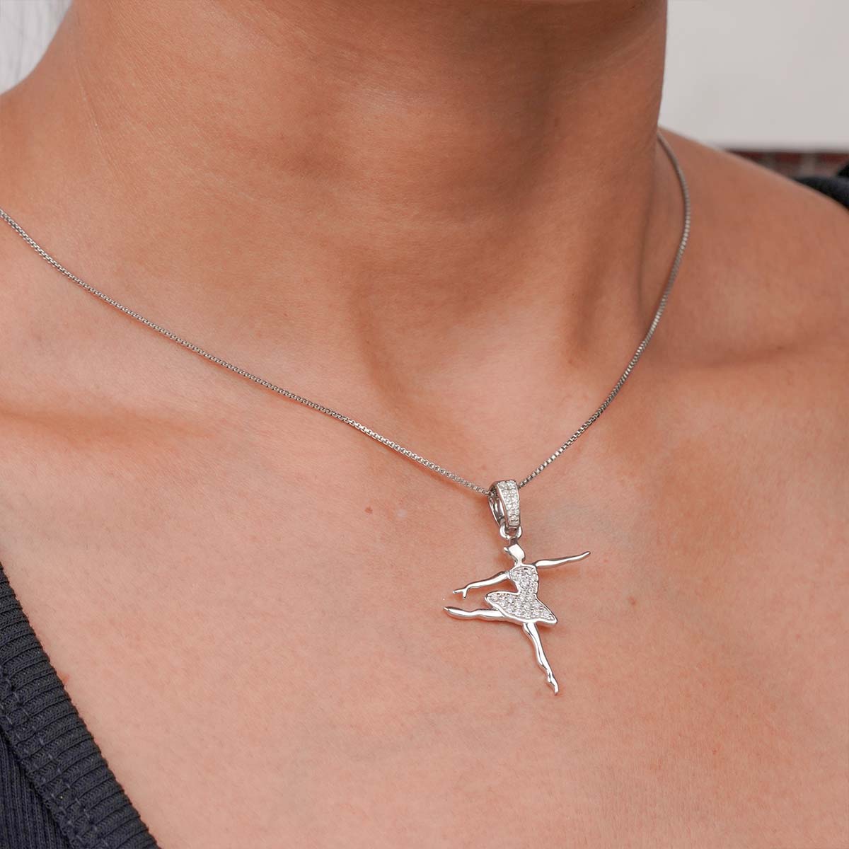 Ballet Dancer pendant Sterling Silver ballerina necklace on a person's neck