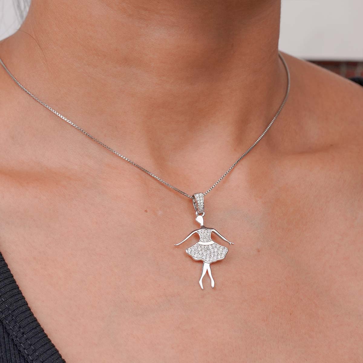 ballerina necklace with a Silver ballet dancer silhouette pendant on a girl's neck