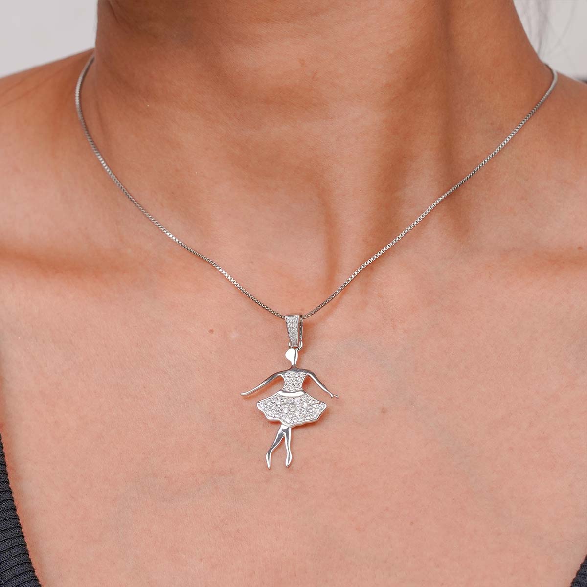 ballerina necklace with a Silver ballet dancer silhouette pendant on a girl's neck