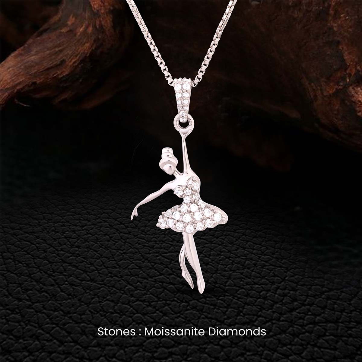 Moissanite diamond studded Silver ballerina pendant necklace on a dark textured background