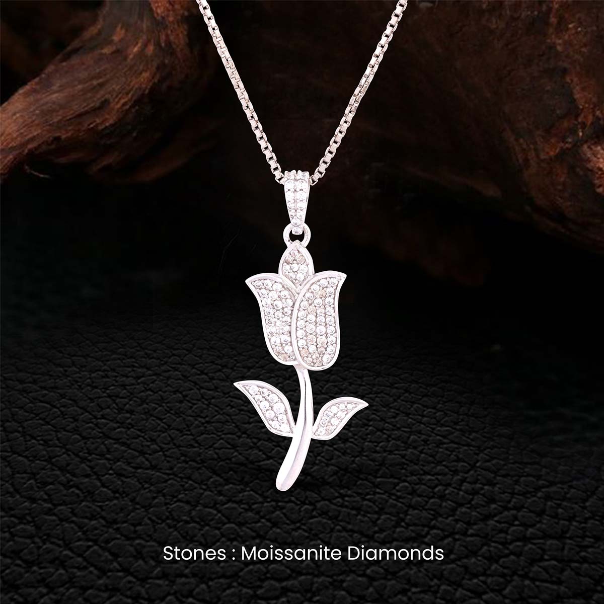 moissanite diamond tulip-shaped pendant necklace on a dark textured background
