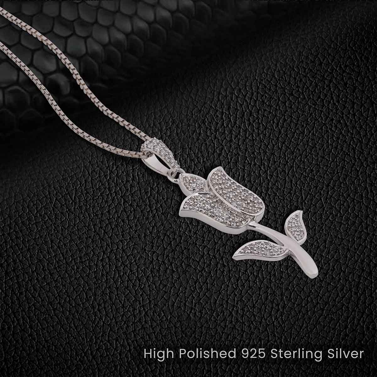 diamond tulip pendant necklace on a black textured background