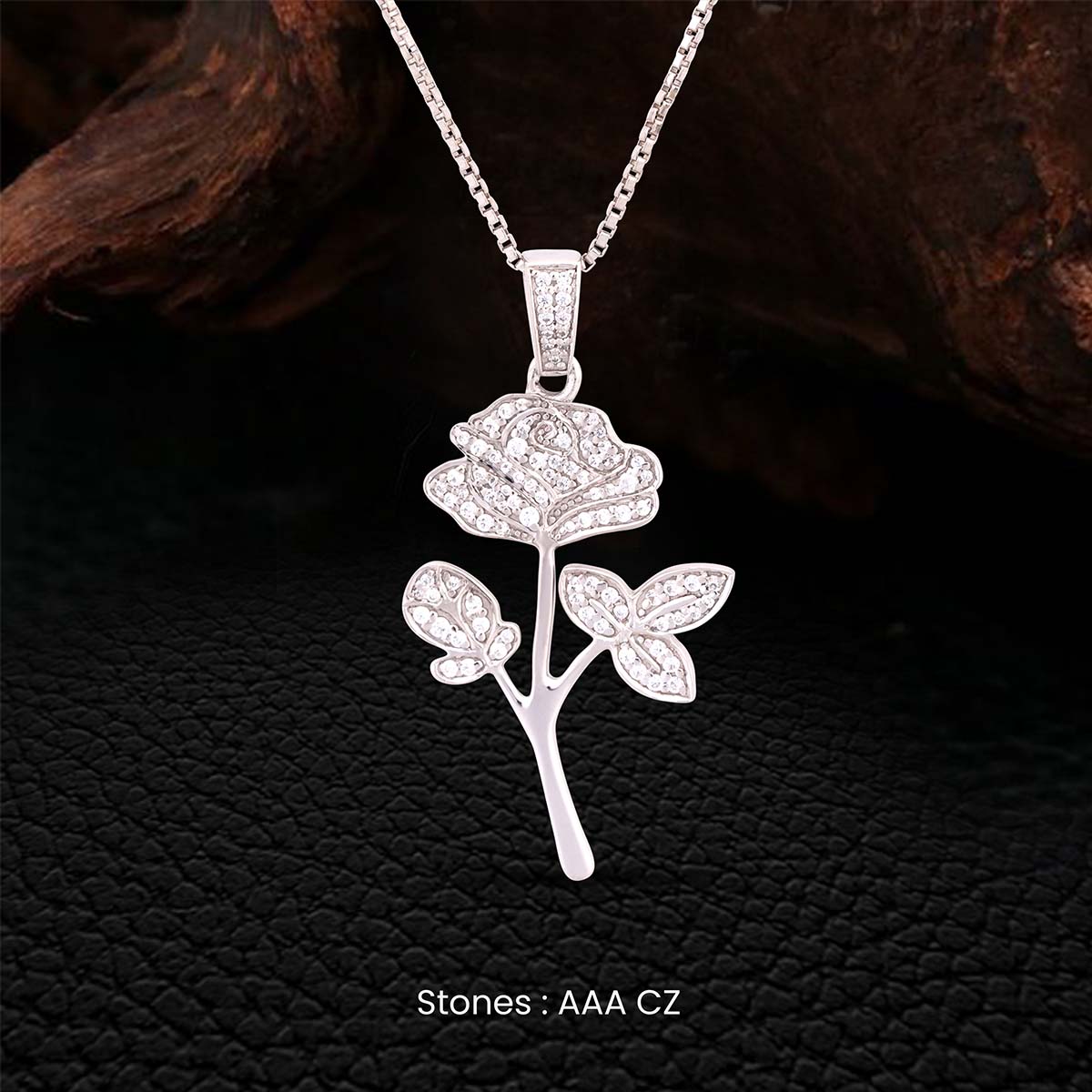 Rose flower pendant necklace in Sterling silver on a dark textured background