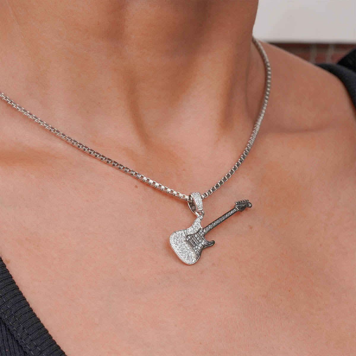 Two Tone Sterling Silver Diamond Studded Iced Out Guitar pendant necklace on a person's neck ( Model View)