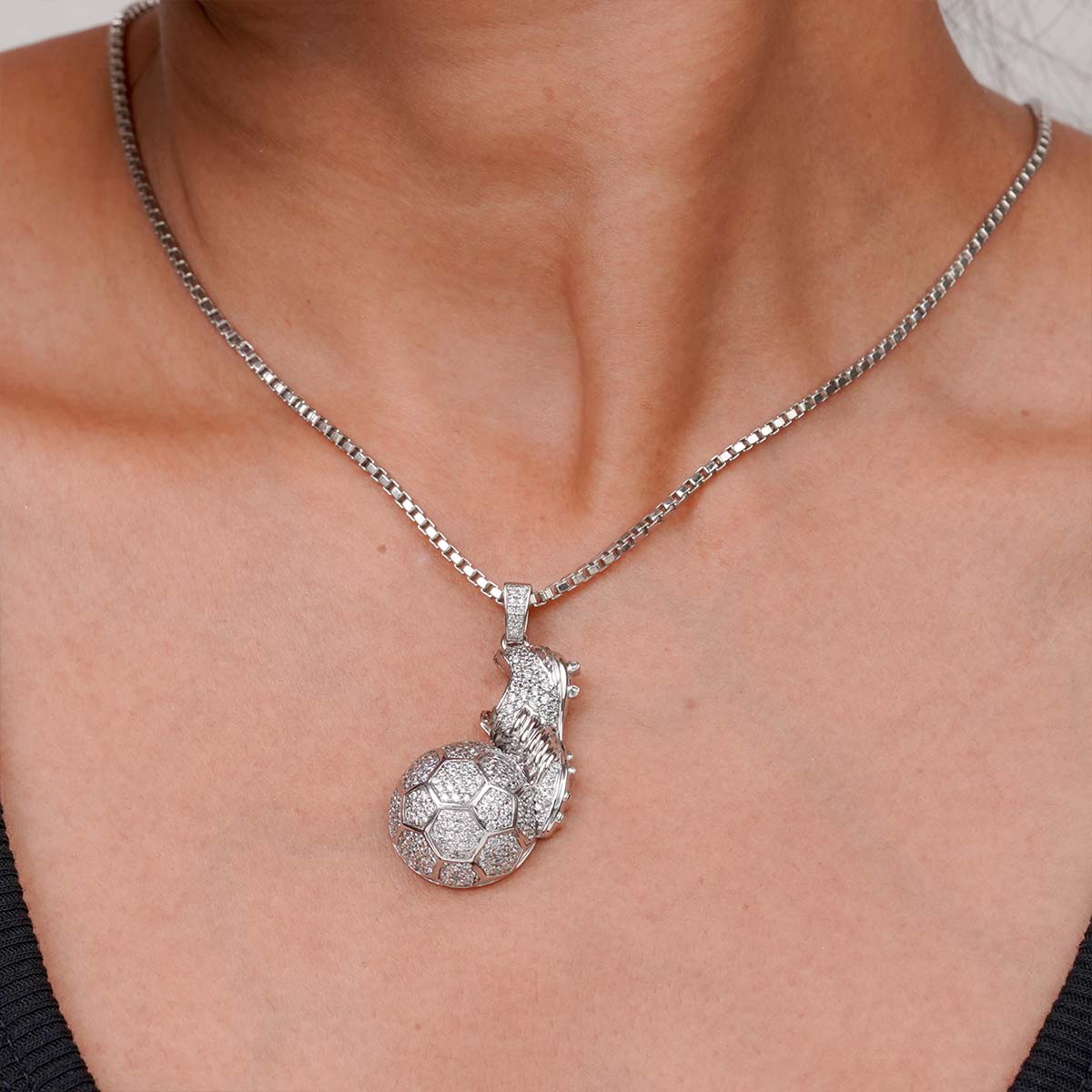 Silver Soccer Ball Shoe Cleat Pendant Necklace on a person's neck