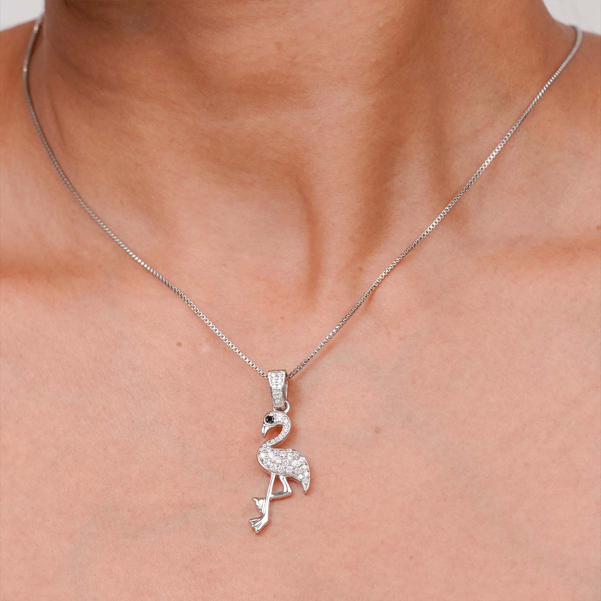 Diamond flamingo pendant necklace on a woman's neck