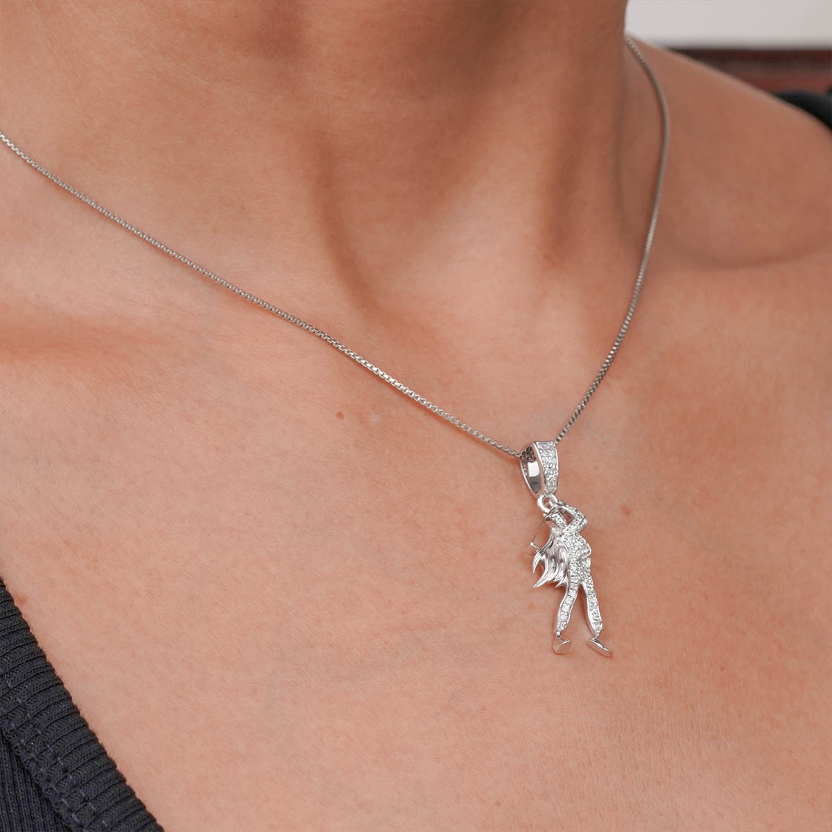 sterling Silver necklace with a golf player silhouette pendant on a person's neck