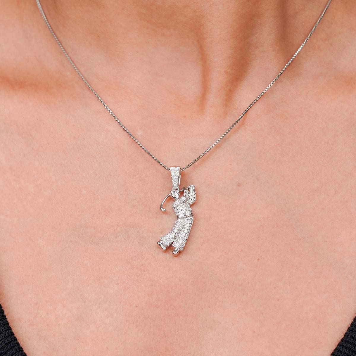 Golfer pendant necklace on a person's neck
