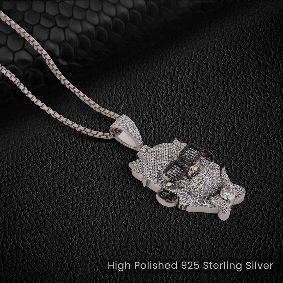 Two tone sterling Silver monkey pendant necklace on a textured black background