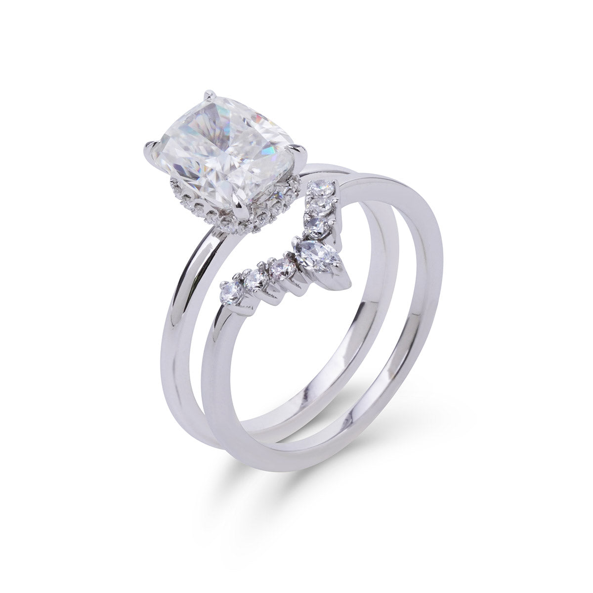 Silver ring with a large central diamond and smaller diamonds on the band against a white background