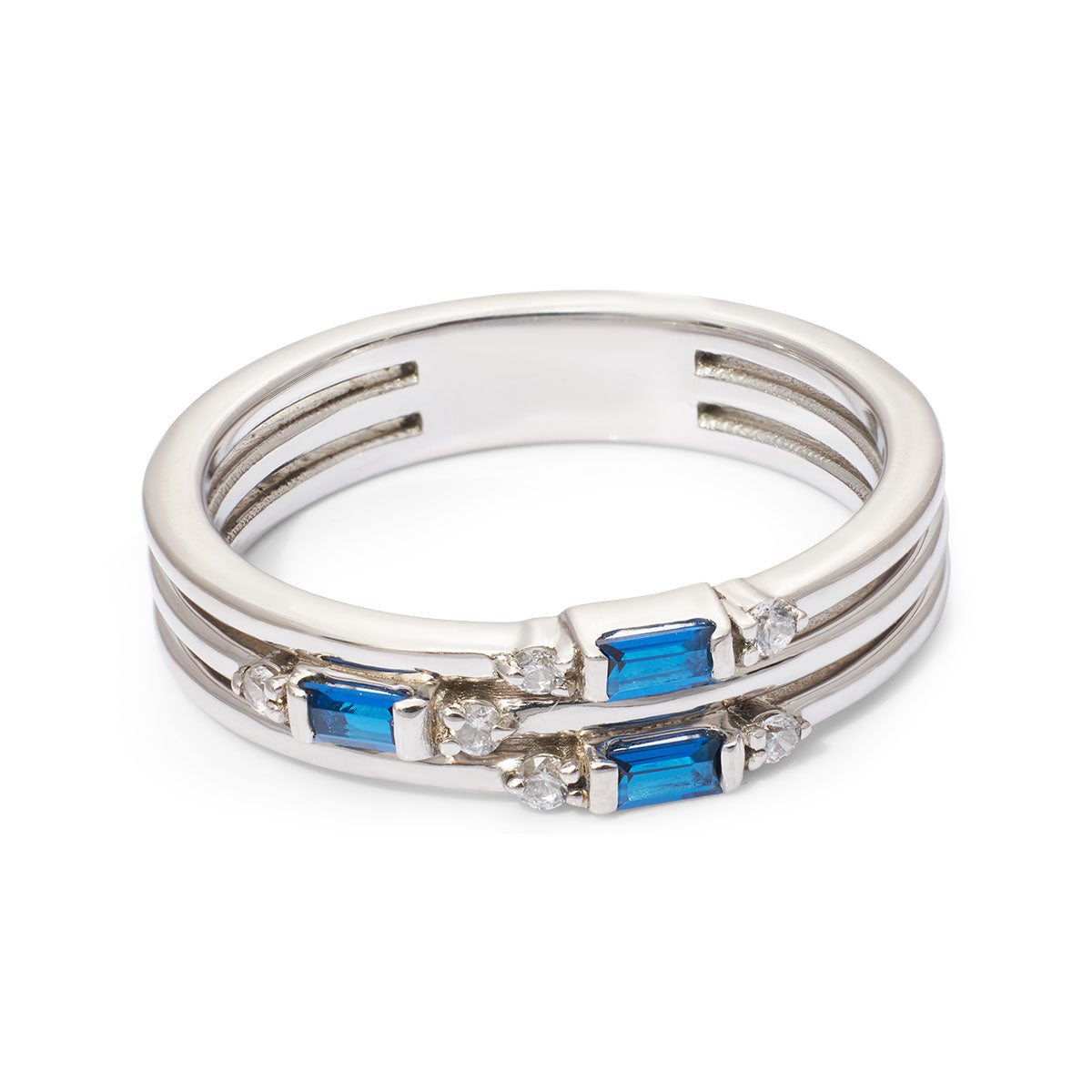 Stack of silver rings with blue gemstones and clear stones on a white background