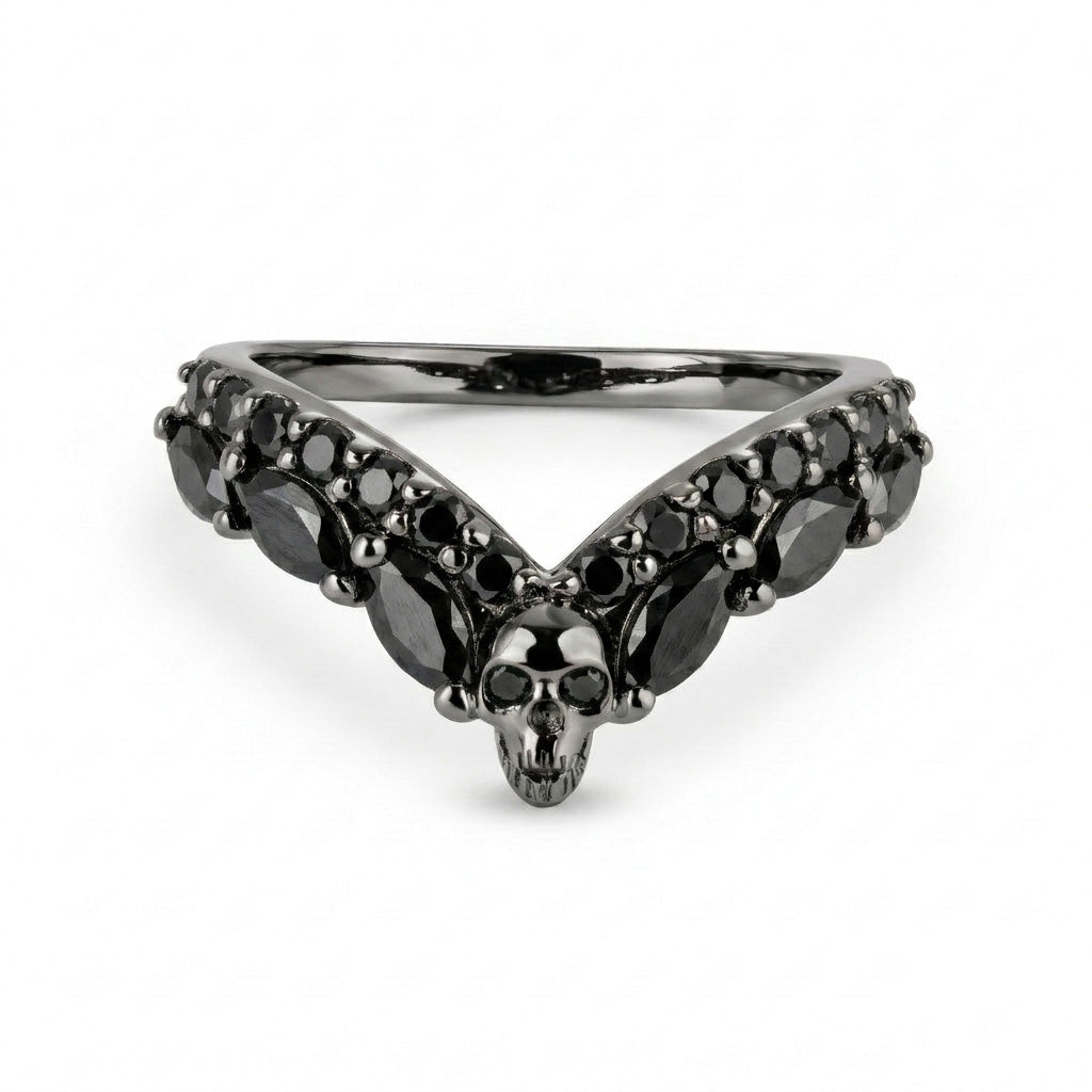 Alternative black wedding band featuring a central skull and V-shaped black onyx cubic zirconia gemstones