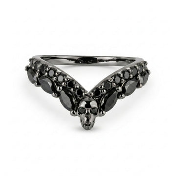 Alternative black wedding band featuring a central skull and V-shaped black onyx cubic zirconia gemstones