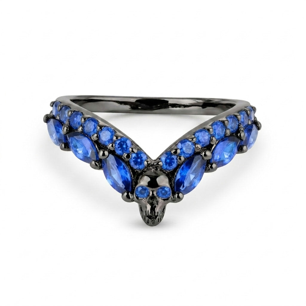 Gothic chevron stacking ring with a detailed skull center and blue sapphire cubic zirconia gemstones